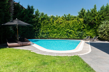 A swimming pool among green trees