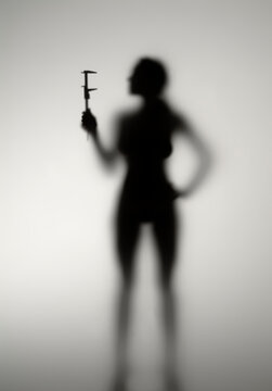 Silhouette of a girl behind opaline glass