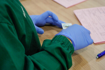 Doctor Preparing Medication and Prescription While Wearing Gloves