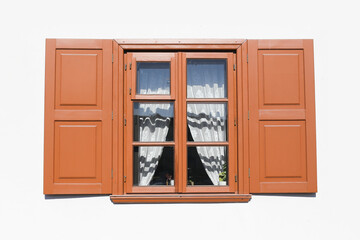 Wooden window isolated on white. Brown paint open window shutters. Object cutout. Lace curtains inside. Rustic wooden frame glass window. Countryside architecture.
