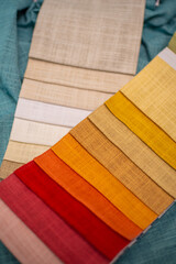 Bright samples of textured fabric for curtains. Red, yellow and green fabric samples.