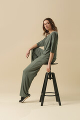 Female model wearing loungewear cotton soft and comfortable outfit, green top and trousers. Classic...