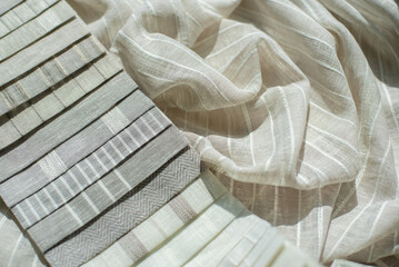 Samples of thin linen tulle striped in beige colors. Samples of linen fabric with shadows.