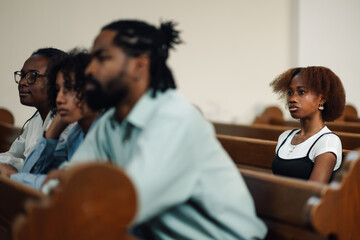 Group of people sitting in church pew listening to sermon