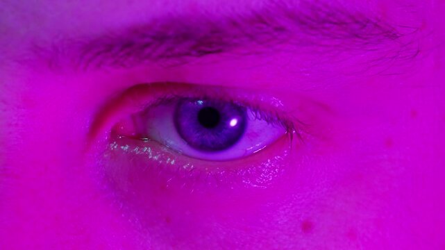 Detailed blue eye with strong gaze, showing human anatomy and beauty, thriller depression halloween style. Drugs concept.