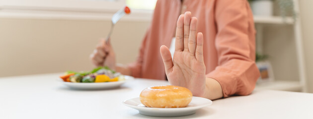 Diet food loss weight concept, Hand of woman pushing sweet away and avoid to sugar to control cholesterol and sugar.