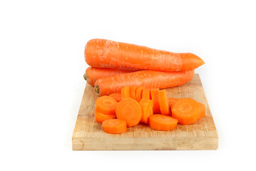 carrots on a wooden chopping board isolated on white 