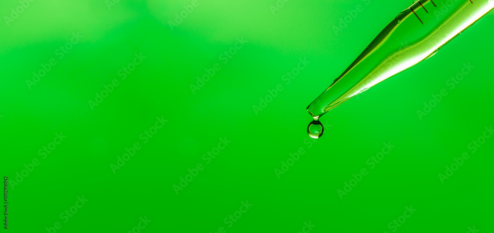 Wall mural close-up science experiment green background,macro green science experiment background,lab glassware