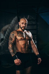 Fitness Man Posing And Showing His Muscles At The Gym