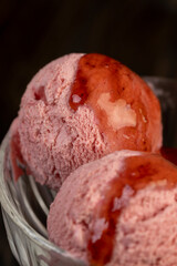 red strawberry ice cream in a glass bowl