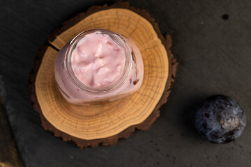 plum yogurt with slices and whole fruits on the table