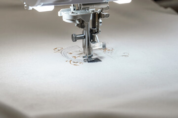 Machine for embroidering colored patterns on fabric.