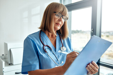 A Dedicated and Committed Nurse Reviewing Patient Charts in a Modern Medical Office Setting