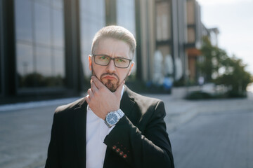 Businessman with glasses and suit reflects deep outdoors