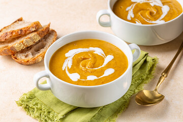 Vegan curried pumpkin lentil soup with vegetable cream and fresh whole grain bread. Healthy...