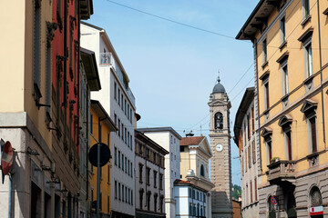 Fototapeta premium Exterior building architecture in the Upper Town, Citta Alta in Bergamo, Lombardy region, Italy. Tower of the church of Sant'Anna at the background.