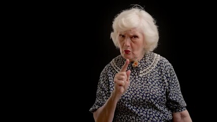 80-year-old woman gesturing no with finger, warning sign, negative attitude