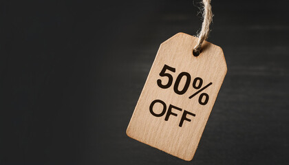 Sale tag with text 50% off on black background. For promoting discounts and shopping events.