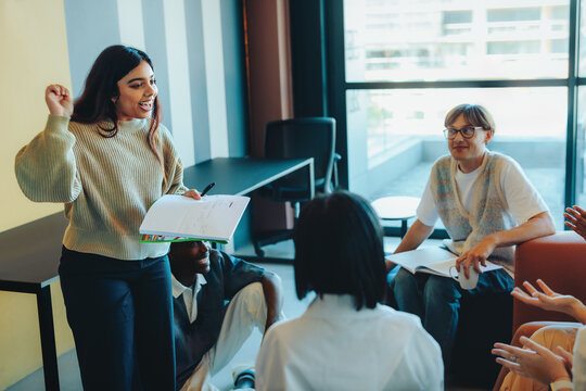 Confident student presenting a project to classmates in a modern classroom setting with attentive audience