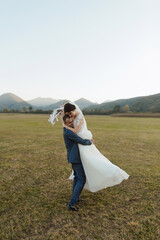 A wedding ceremony is taking place in a beautiful outdoor setting. The ceremony is taking place in...