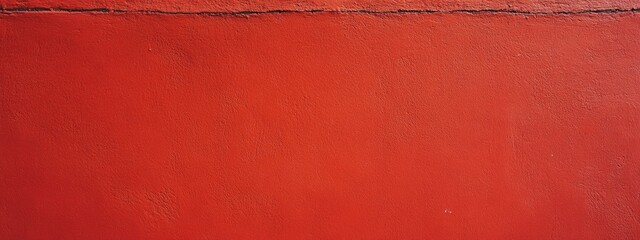 Close-up of texture of the a vivid red plaster wall.