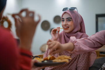 A group of friends enjoying delicious food together in a warm, joyful atmosphere