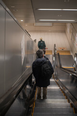 person on the subway escalator