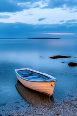 Naklejka premium Lonely boat on calm water during twilight, serene coastal scene.