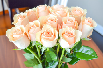 Bouquet of delicate pastel-colored roses, arranged in an elegant vase