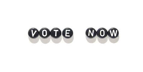 Vote now message in black and white beads on white background for election awareness.