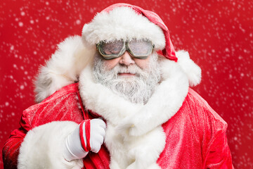 Close up photo of stylish elderly hipster santa carry bag sack ready deliver present in stormy cataclysm wear white gloves fur sleeves cap isolated over red color background