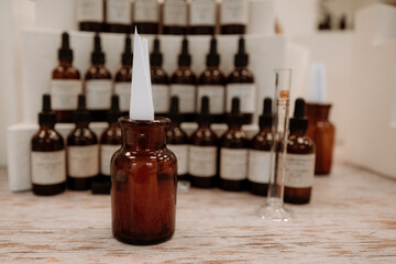 Clean mockup of glass brown bottle with white blotter paper for testing smell of fragrance oil or essential oil, perfume tester paper strips, study of perfumery and aromatherapy