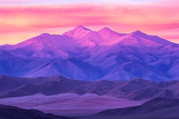 Fototapeta premium The sky transitions to rich pink and purple tones as sunlight casts shadows over towering mountains and tranquil valleys during sunset
