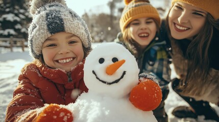 Happy children sculpting funny snowman together with parents in winter snow-covered park. Happy family mother and children having fun on winter walk.