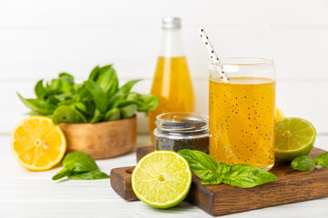 Diet detox cocktail with basil and chia seeds in a glass jar and a glass on a textured background. Drink with seeds. Health food. Detox cocktail. Antioxidant. Water with basil. Space for text. 