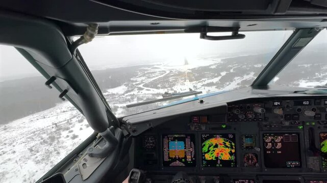 Cockpit captain pilot forward view while landing on snow covered contaminated winter runway Stockholm Sweden