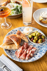 charcuterie, meats, cheese, meat, cheese, olive, olives, pita, lunch, snack, Mediterranean, Mediterranean food, mezzo, prosciutto, happy hour, meal, food, plate, vegetable, cuisine, restaurant, fresh