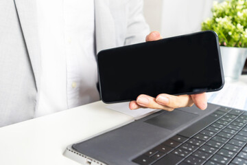 A mobile mockup where the executive holds up a screen to insert graphics or text.