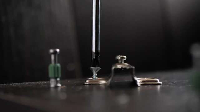 Installing hinges on a furniture door using a Phillips screwdriver. furniture assembly.