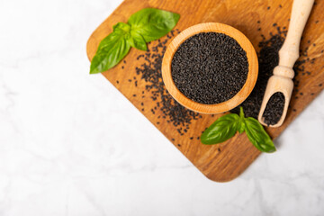 Basil seeds on textured wooden background. Close-up. Superfood. Ocimum basilicum. Organic basil seeds. selasih. Space for text. Copy space.