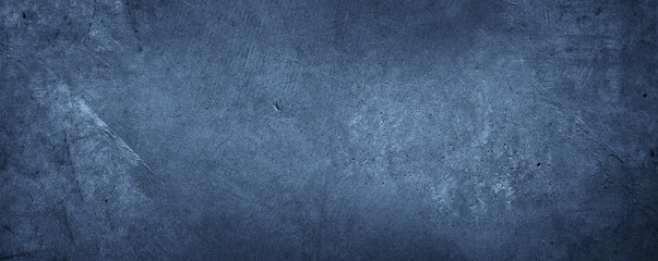 Blue textured concrete wall dark background