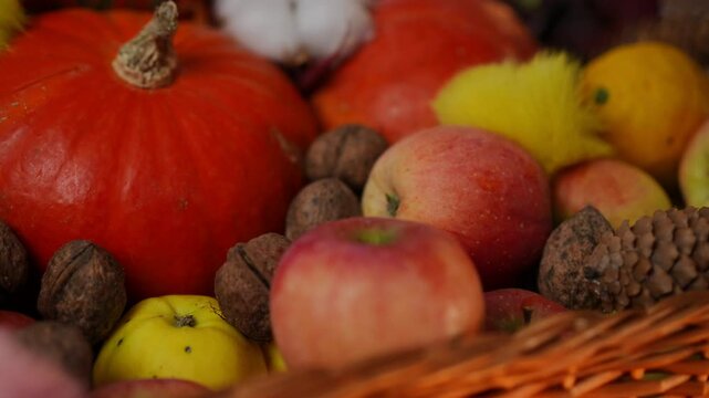 A cozy autumn display featuring a variety of fruits, pumpkins, and beautiful candles for a warm seasonal vibe this fall