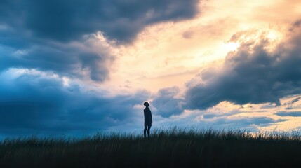 silhouette of solitary figure against ethereal cloudy sky spiritual theme dramatic lighting contemplative mood vast landscape