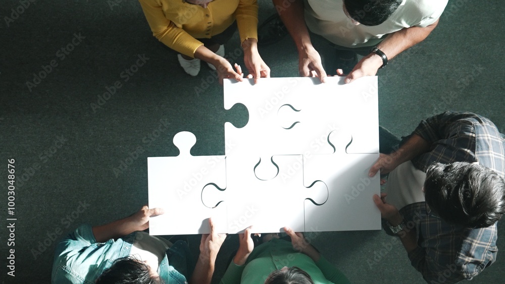Aufkleber top down view of business people put last piece of jigsaw puzzle together to complete puzzle and sta