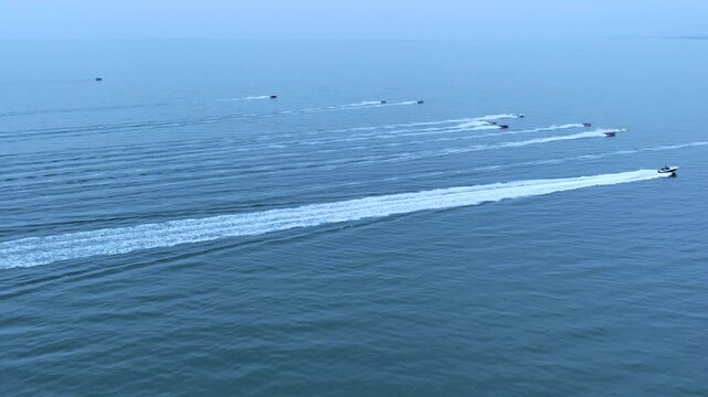 Aerial view of some offshore speedboats sailing on the blue waters of the Adriatic Sea. Cervia, Ravenna, Italy