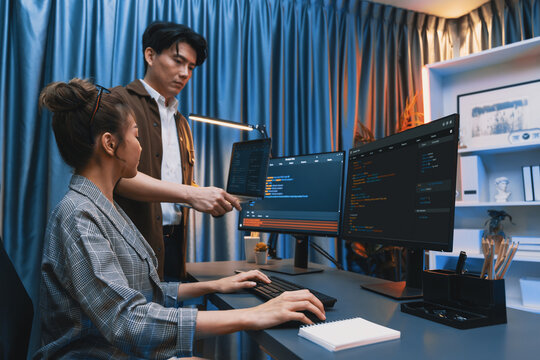 Serious of IT developers discussing intelligent website development coder system running data online two screens with laptop showing information network at neon light room at modern office. Infobahn.