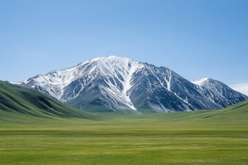Snow-capped peaks tower over vibrant green pastures, creating a stunning landscape bathed in the morning sun