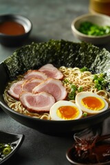 Delicious bowl of ramen topped with grilled chicken, green onions, and a soft-boiled egg