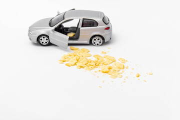 Gray toy car and food crumbs on white background. Dirt in the car interior