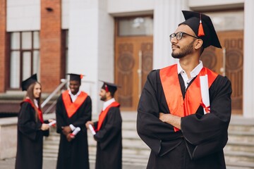 Confident Indian Male Graduate Standing Proud With Diploma at University Ceremony